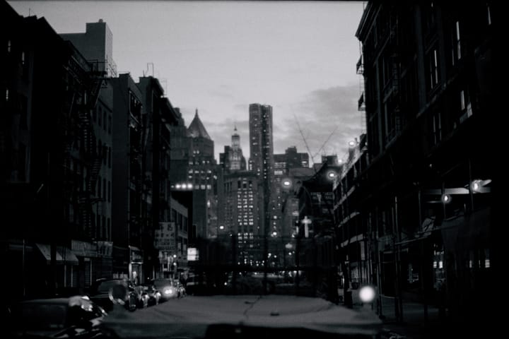 city view at dusk with lights on in buildings